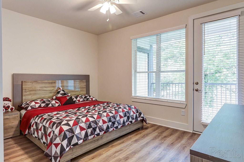 a bedroom with a bed and two windows