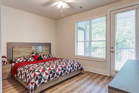 a bedroom with a bed and two windows