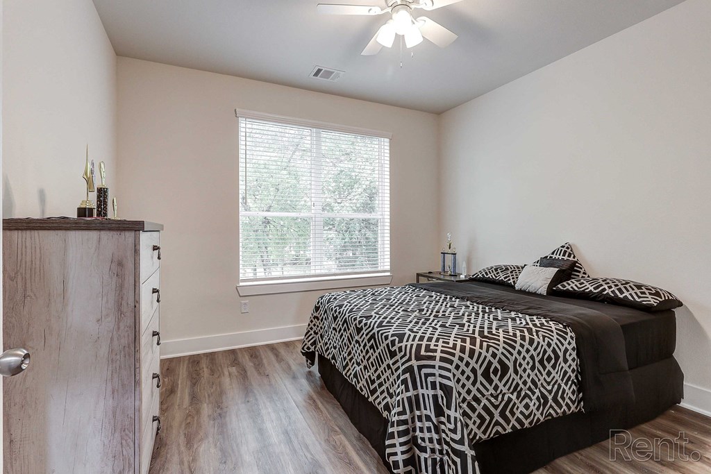 a bedroom with a bed and a window