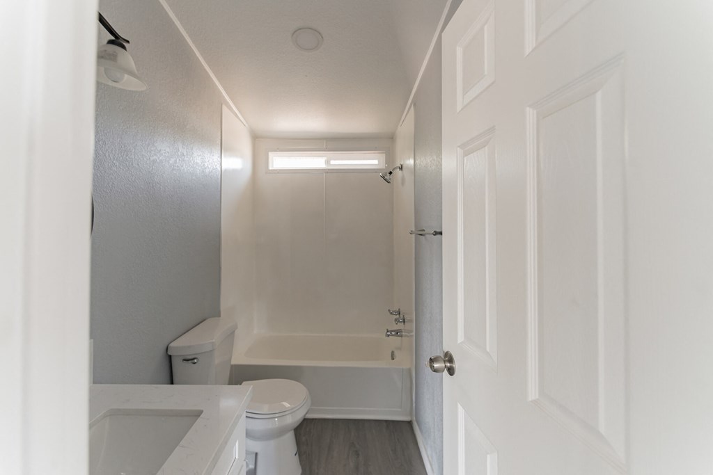 an empty bathroom with a toilet and a shower