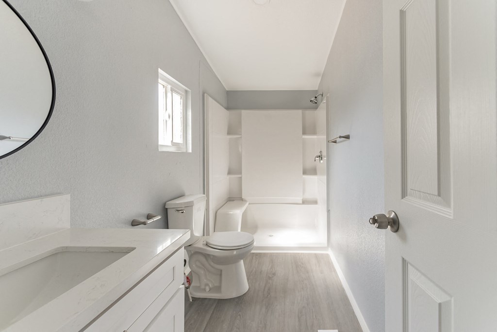a white bathroom with a toilet and a tub and a sink