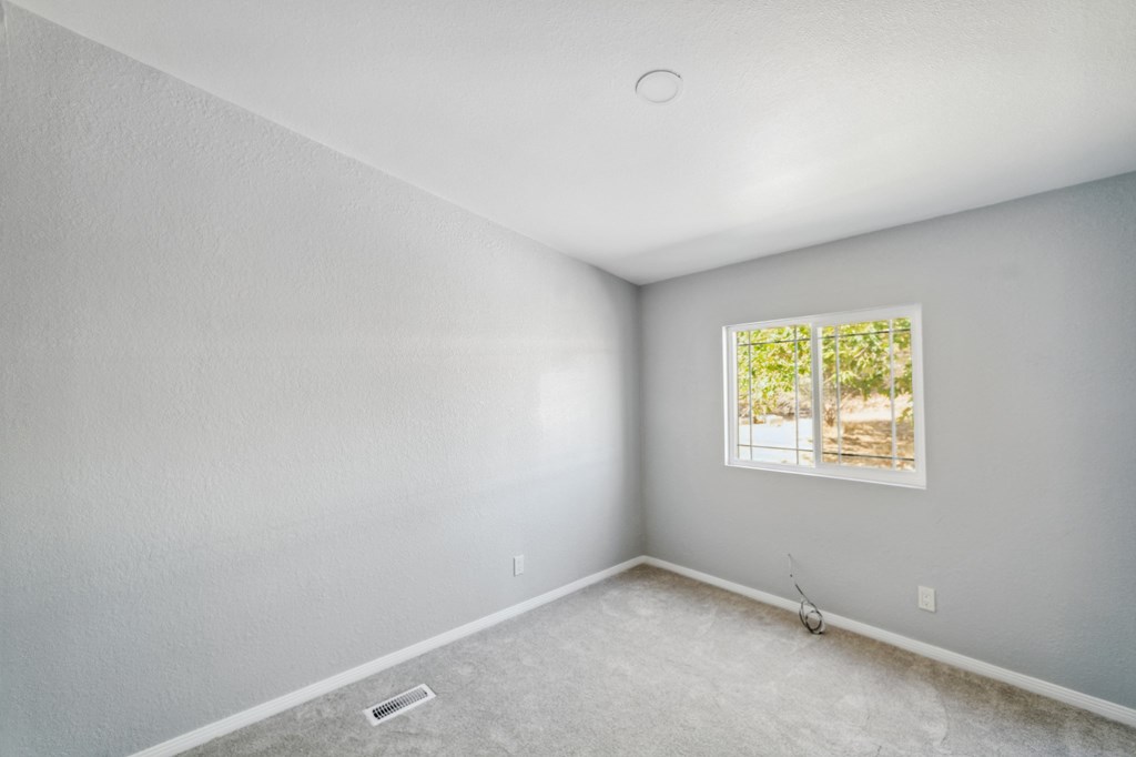 a room with white walls and a window