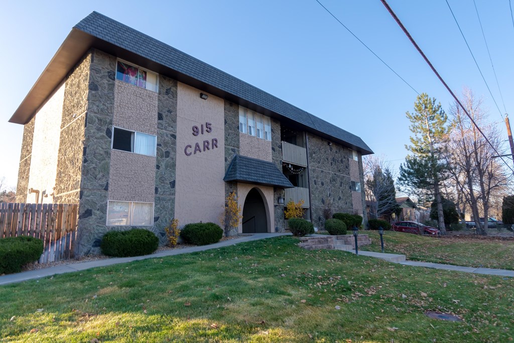 a stone building with a lawn in front of it