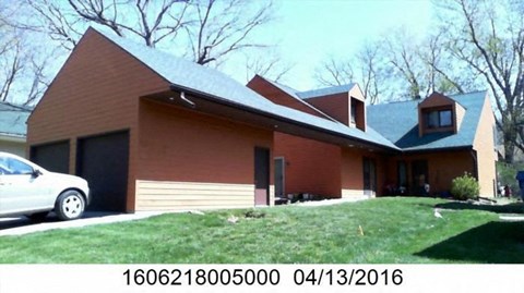 A house with a car parked in front of it.