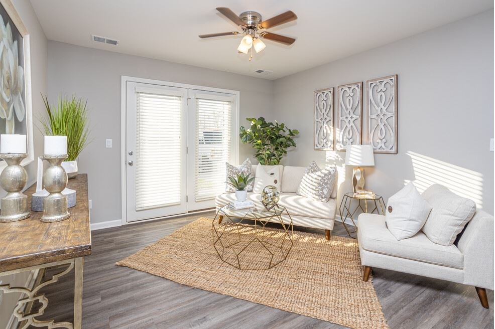 a living room with a couch and a ceiling fan