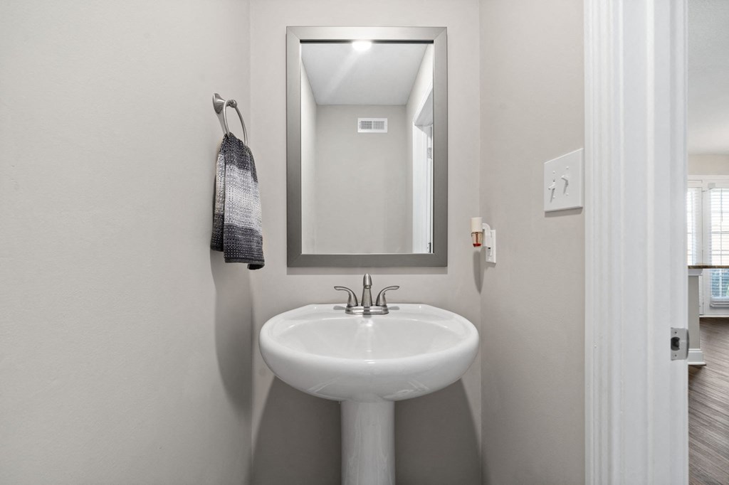 a small bathroom with a sink and a mirror