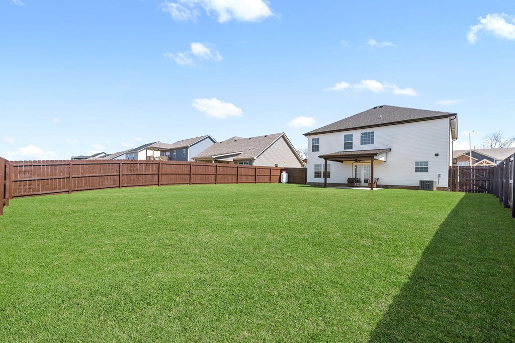 the backyard of a house with a wooden fence