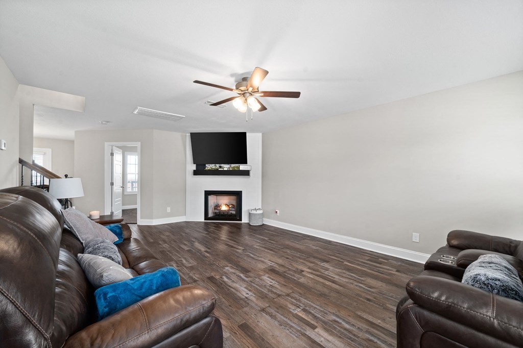a living room with leather furniture and a fireplace