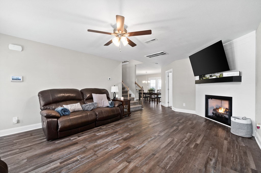 a living room with a leather couch and a fireplace