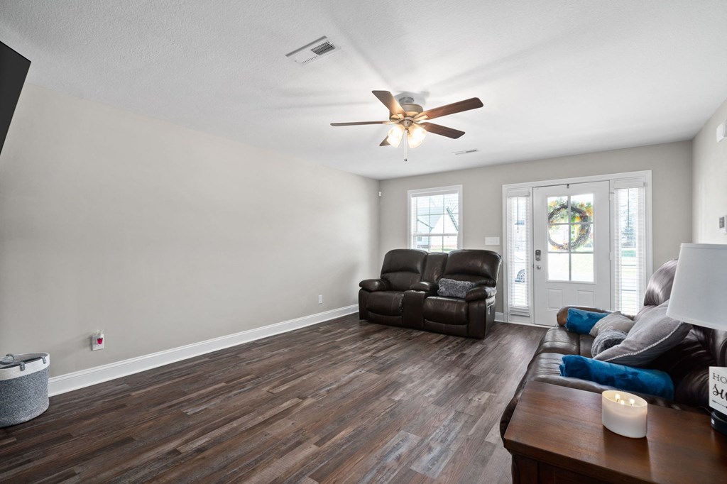 a living room with a couch and a ceiling fan
