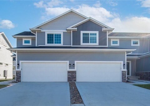 A two-story house with a garage.