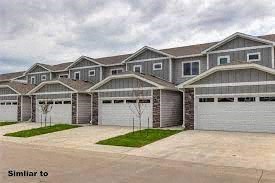 this is a picture of a house with garage doors