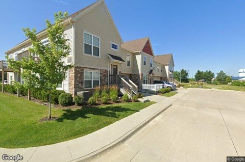 A street view of a residential area with houses on both sides.