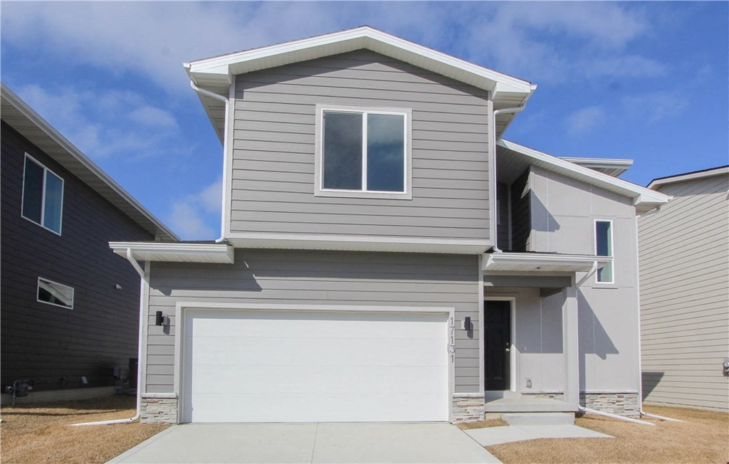 a gray house with a white garage door