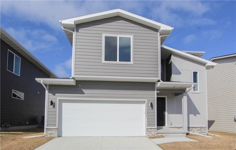a gray house with a white garage door