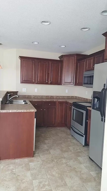 A kitchen with brown cabinets and a tiled floor.
