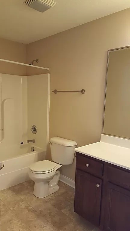 A white toilet sits in a bathroom next to a white sink.