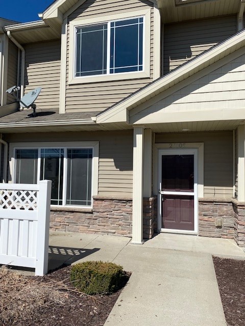 A house with a white fence and a brown door.