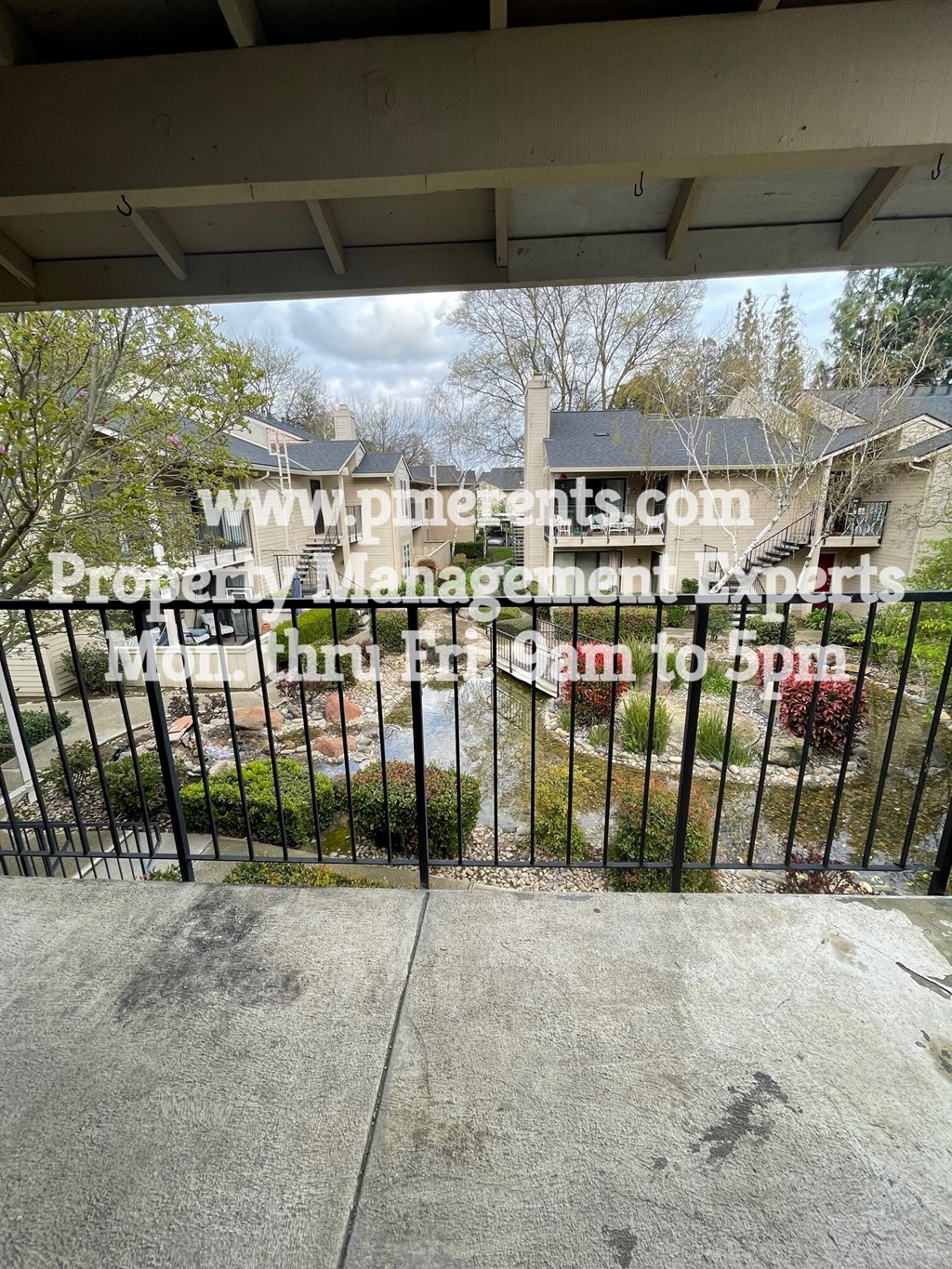 a gate in front of a house with a yard behind it