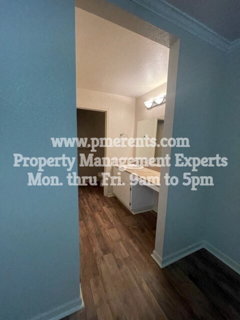 a small room with a hallway and a door to a bathroom