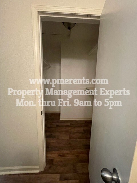 a small hallway with a door open to a closet