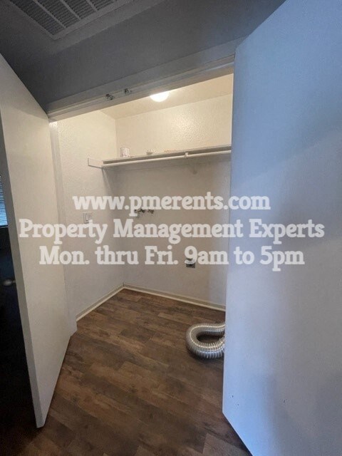 a small room with a white wall and a closet