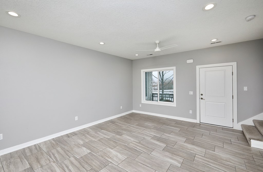 A room with a fan and a door.