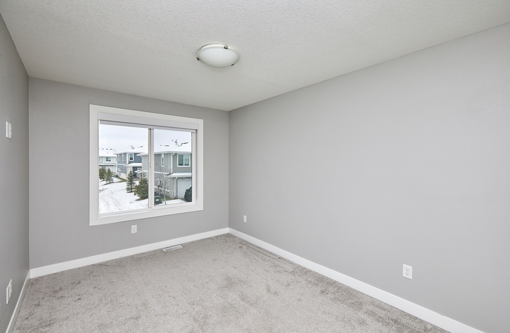 A room with a window showing a snowy landscape outside.