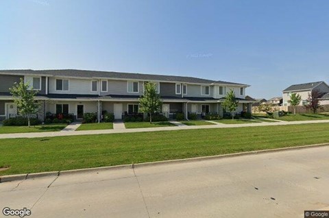 A street view of a residential area with apartment buildings.