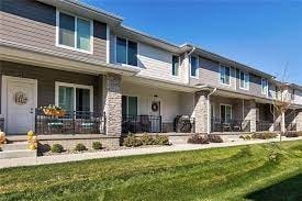 A row of houses with front yards and driveways.