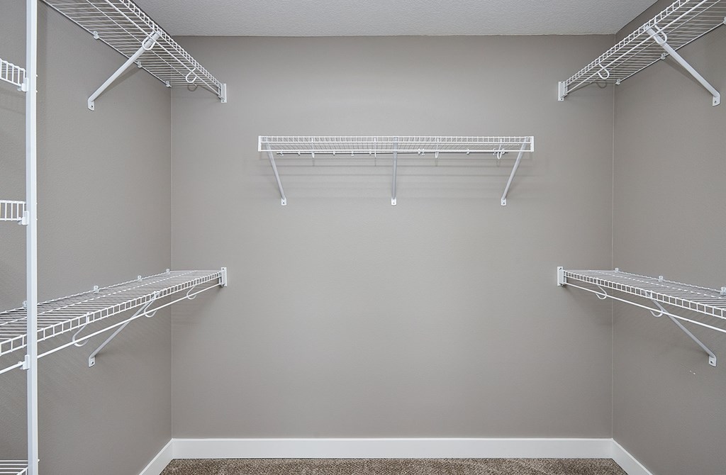 Empty white shelves in a room.