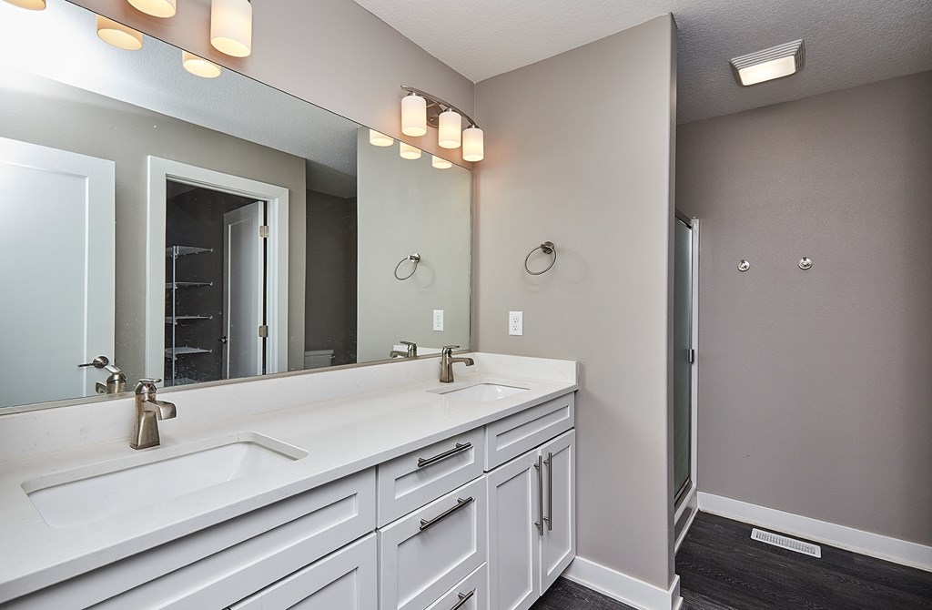 A bathroom with a white sink and a mirror.