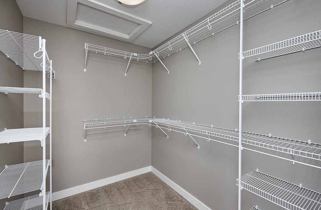 Empty white shelves in a room.