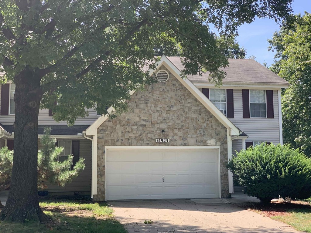 a stone house with a white garage door