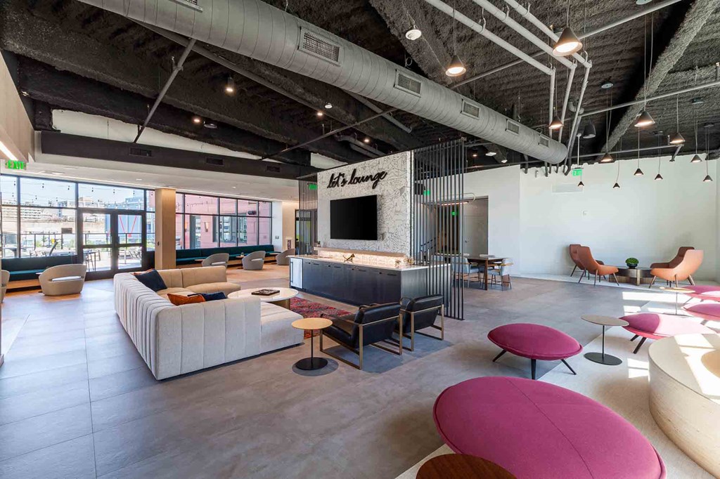 A modern living room with a white couch and a television.