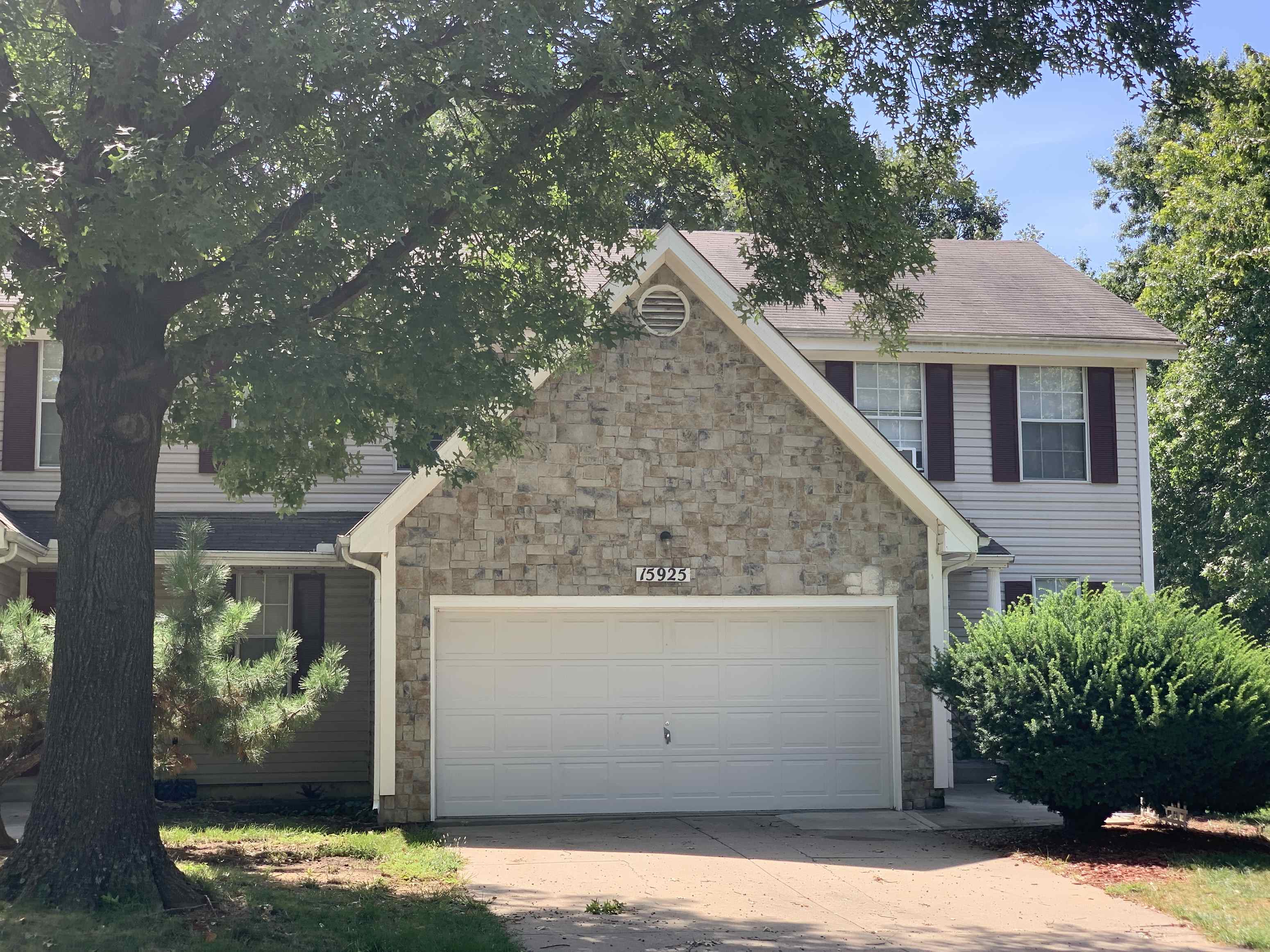 a stone house with a white garage door