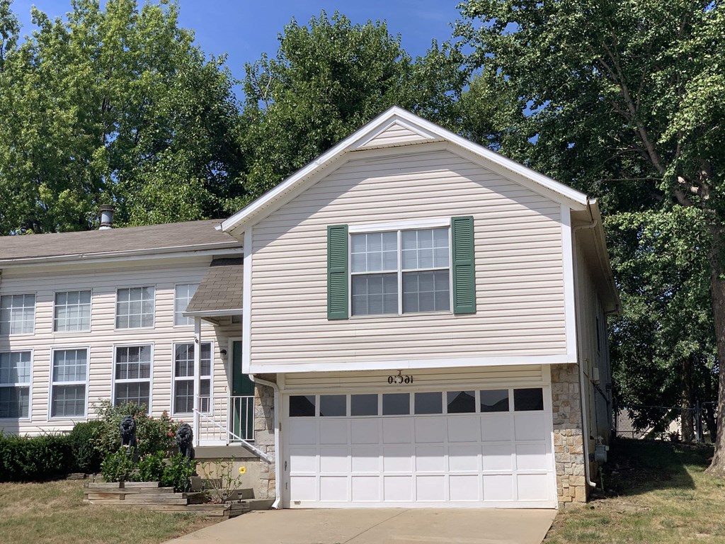 a white house with a white garage door