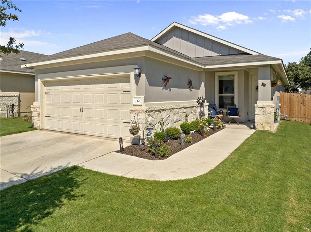 a house with a driveway and a garage door