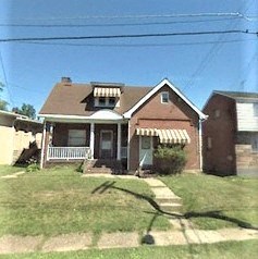 A house with a brown roof and a white awning.