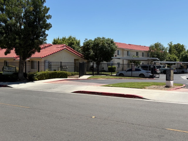 A street view of a residential area with houses and a parked car.