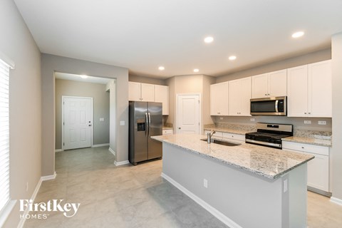 a large kitchen with stainless steel appliances and granite counter tops