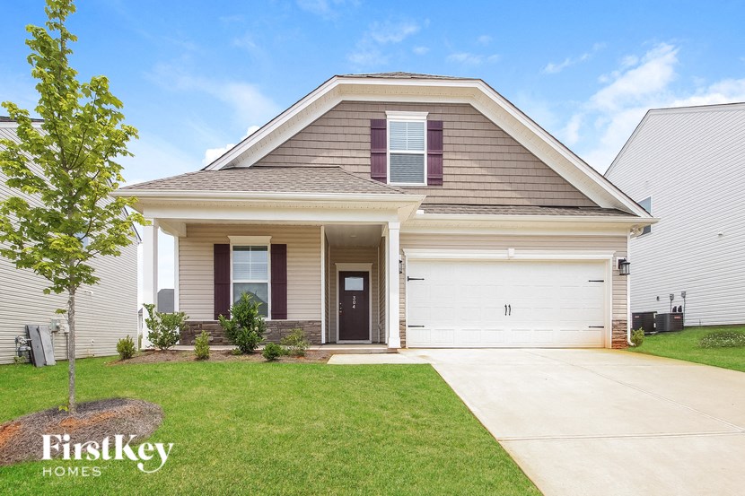 a house with a white garage door and a lawn