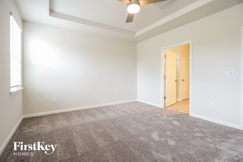 an empty living room with white walls and carpet