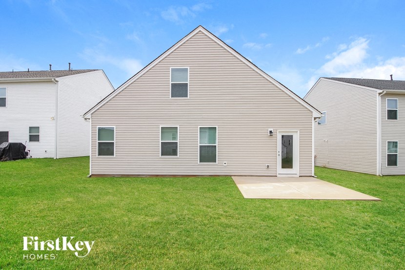 a white house with a yard in front of it