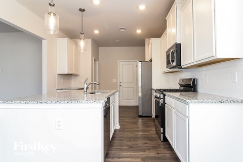 a kitchen with white cabinets and a white counter top