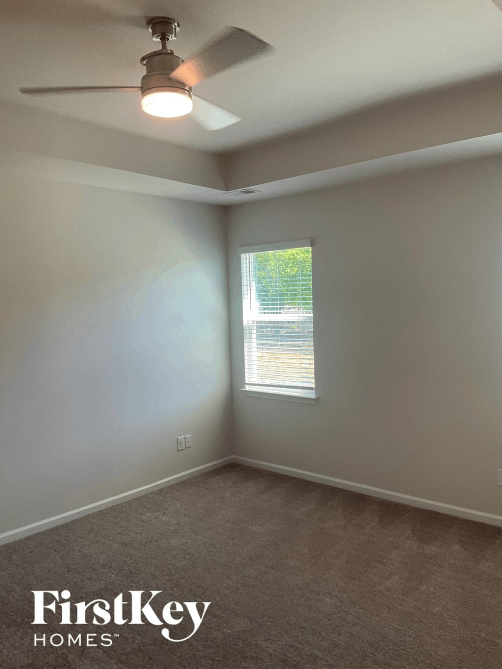 a bedroom with a ceiling fan and a window