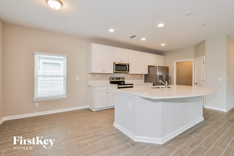 a kitchen with white cabinets and a white counter top