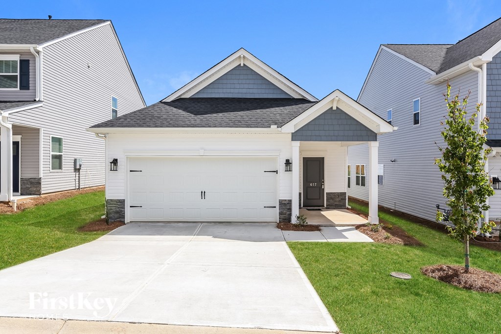 two story home with white siding and a white garage door