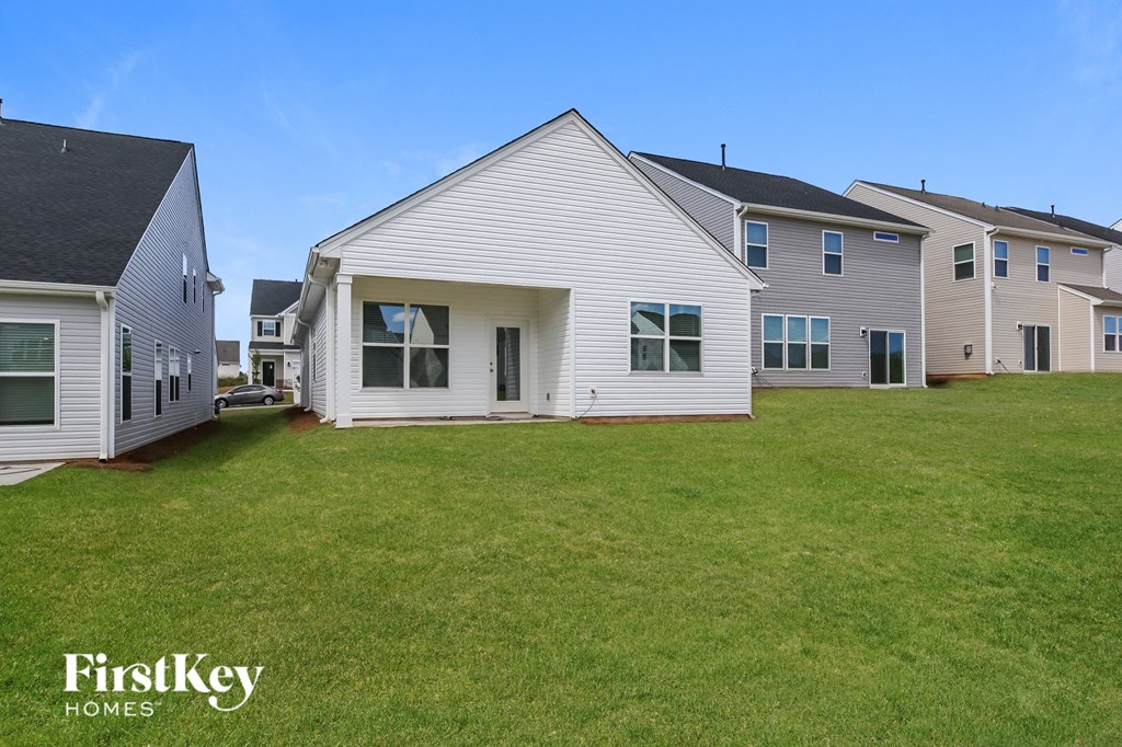 a white house with a yard in front of it