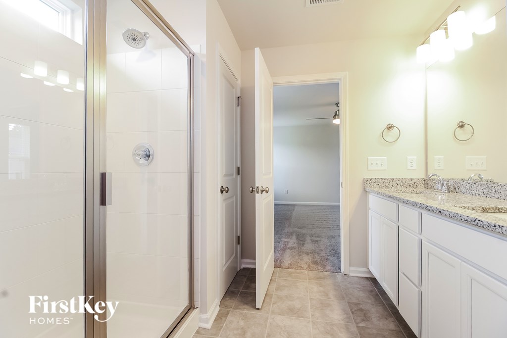 A bathroom with a walk-in shower and a sink.